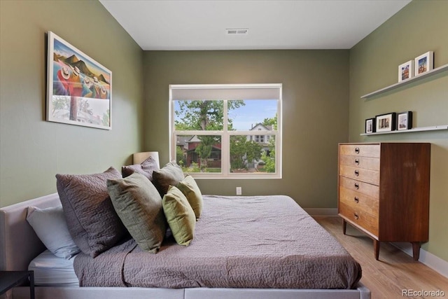 2533 N Emerson St, Denver, CO 80205 - bedroom featuring wood finished floors and baseboards