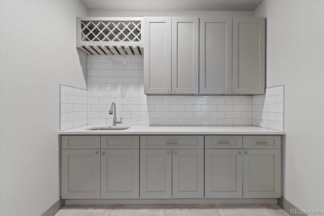 2533 N Emerson St, Denver, CO 80205 - kitchen featuring a sink, gray cabinetry, light countertops, and backsplash
