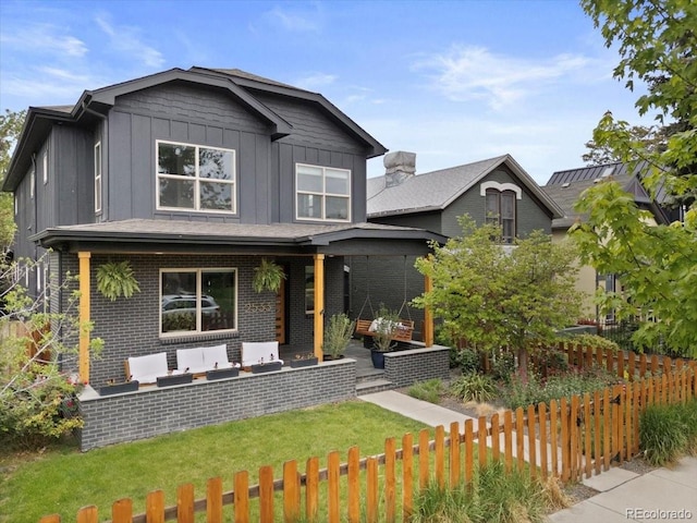 2533 N Emerson St, Denver, CO 80205 - view of front facade with board and batten siding, brick siding, and an outdoor living space