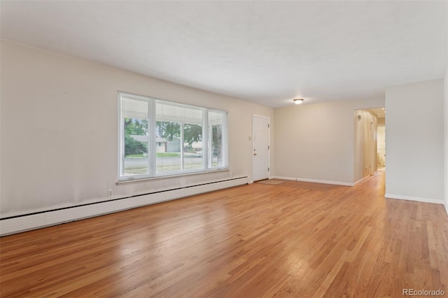 3030 S University Blvd, Denver, CO 80210 - empty room with a baseboard heating unit and light wood finished floors