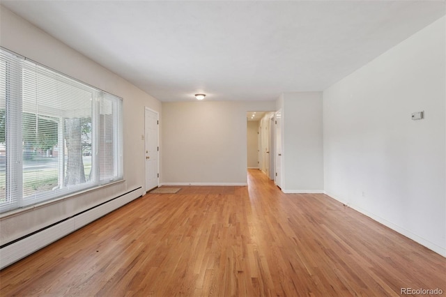3030 S University Blvd, Denver, CO 80210 - empty room with baseboard heating and light wood finished floors