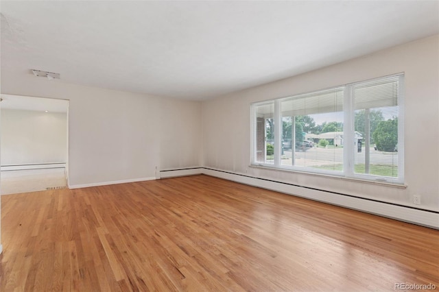 3030 S University Blvd, Denver, CO 80210 - spare room with light wood-style floors and a baseboard radiator