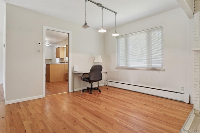 3030 S University Blvd, Denver, CO 80210 - home office featuring baseboard heating and light wood-style flooring