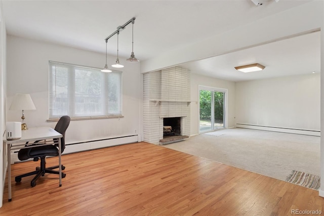 3030 S University Blvd, Denver, CO 80210 - office area featuring a baseboard heating unit, wood finished floors, a baseboard radiator, and a brick fireplace