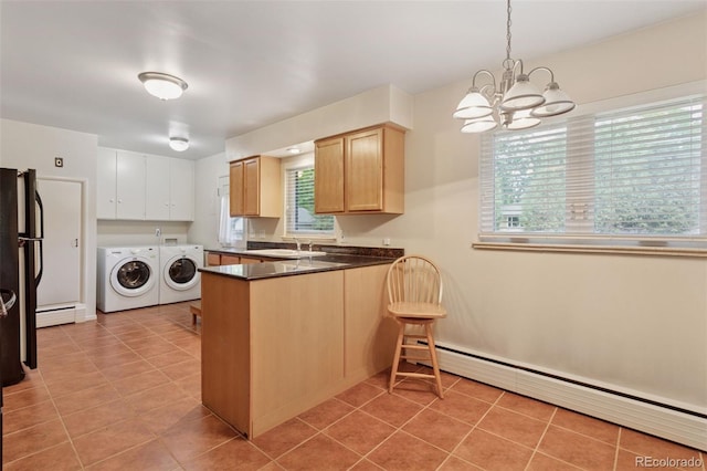 3030 S University Blvd, Denver, CO 80210 - kitchen with washing machine and clothes dryer, a baseboard radiator, a peninsula, and a chandelier
