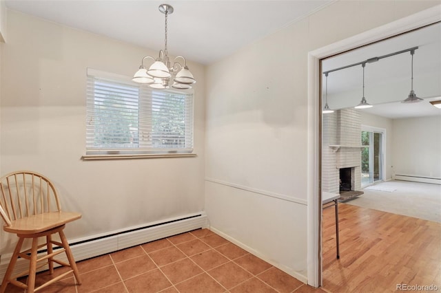 3030 S University Blvd, Denver, CO 80210 - unfurnished dining area featuring a baseboard heating unit, a chandelier, and a fireplace