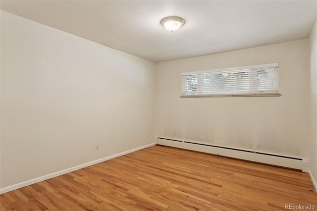 3030 S University Blvd, Denver, CO 80210 - empty room with a baseboard radiator and light wood finished floors