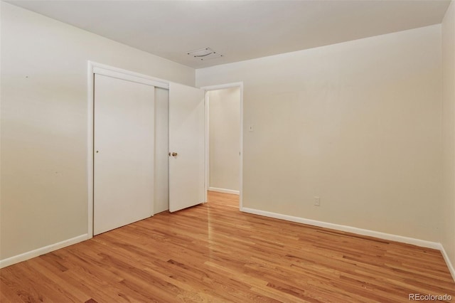 3030 S University Blvd, Denver, CO 80210 - unfurnished bedroom featuring light wood-style flooring and a closet