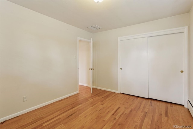 3030 S University Blvd, Denver, CO 80210 - unfurnished bedroom with light wood-style floors and a closet