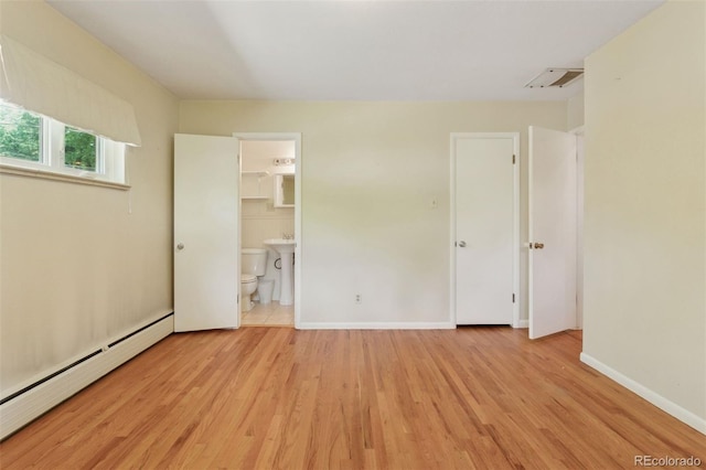 3030 S University Blvd, Denver, CO 80210 - unfurnished bedroom featuring baseboard heating, light wood-style floors, and ensuite bath