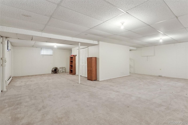 3030 S University Blvd, Denver, CO 80210 - finished below grade area featuring a baseboard heating unit, a drop ceiling, and carpet floors