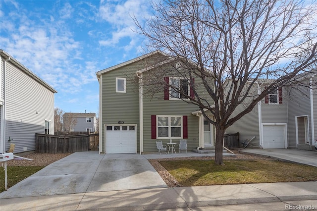 view of front of home featuring a garage, concrete driveway, and fence