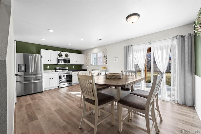 dining area with recessed lighting, light wood-type flooring, and visible vents