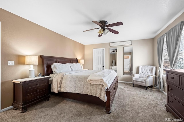 carpeted bedroom featuring baseboards and ceiling fan