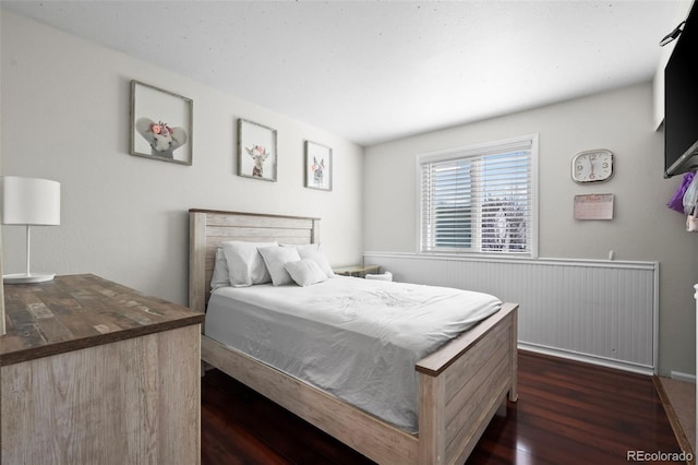 bedroom with dark wood-style floors