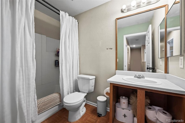 full bathroom with toilet, vanity, and baseboards