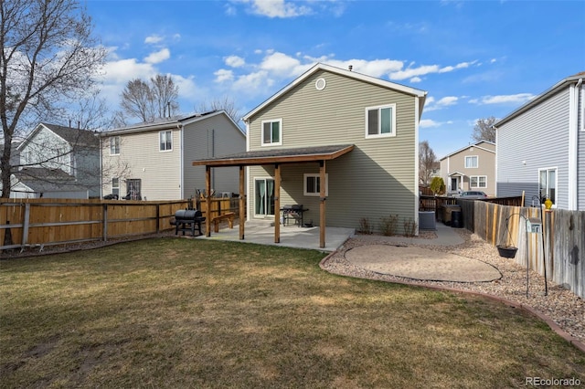 back of house with a yard, a patio, and a fenced backyard