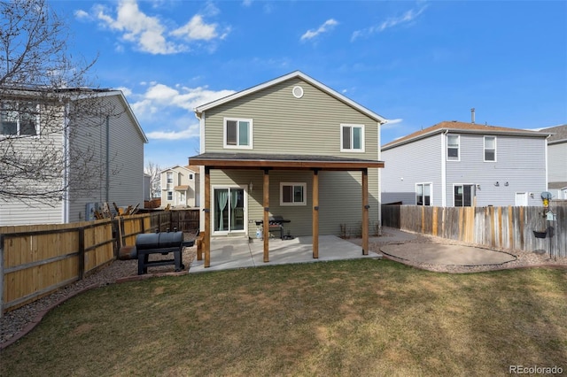 back of property featuring a yard, a fenced backyard, and a patio