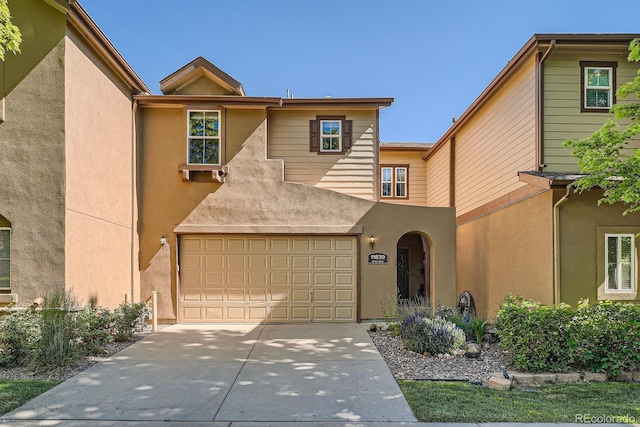 11839 E Fair Ave, Greenwood Village, CO 80111 - townhome / multi-family property featuring stucco siding, an attached garage, and concrete driveway