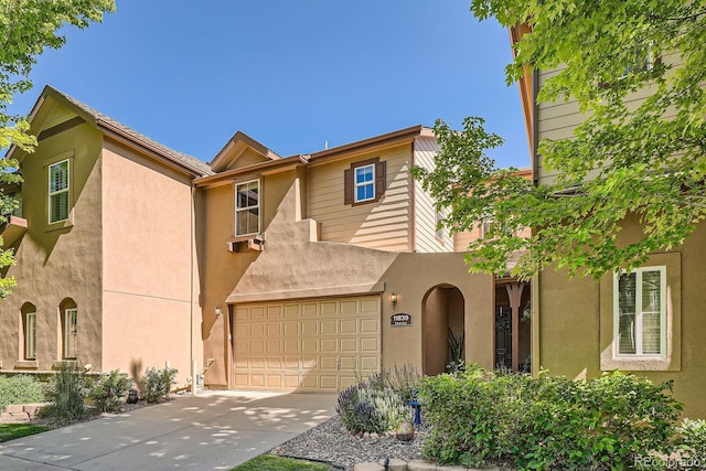 11839 E Fair Ave, Greenwood Village, CO 80111 - view of front of home featuring a garage, driveway, and stucco siding