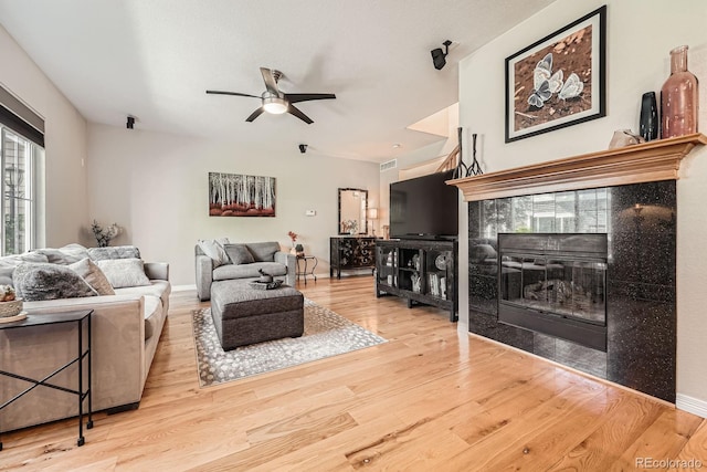 11839 E Fair Ave, Greenwood Village, CO 80111 - living room with a tile fireplace, wood finished floors, and ceiling fan