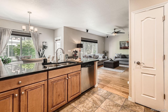 11839 E Fair Ave, Greenwood Village, CO 80111 - kitchen with stainless steel dishwasher, brown cabinetry, a ceiling fan, healthy amount of natural light, and a textured ceiling
