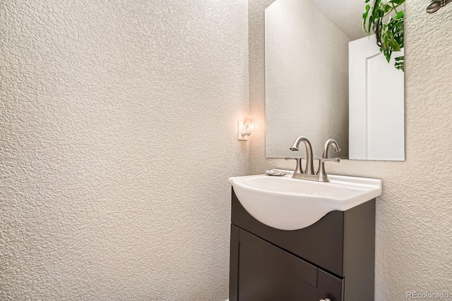 11839 E Fair Ave, Greenwood Village, CO 80111 - bathroom featuring vanity and a textured wall