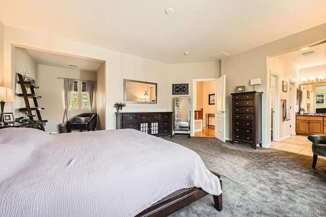 11839 E Fair Ave, Greenwood Village, CO 80111 - carpeted bedroom featuring ensuite bath and a chandelier
