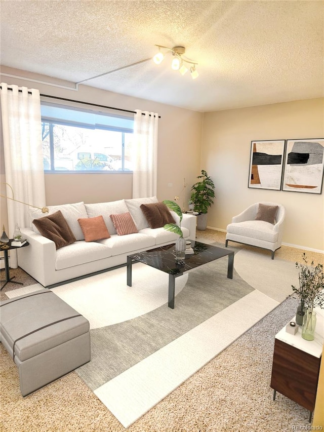 living area with a textured ceiling, baseboards, and carpet floors