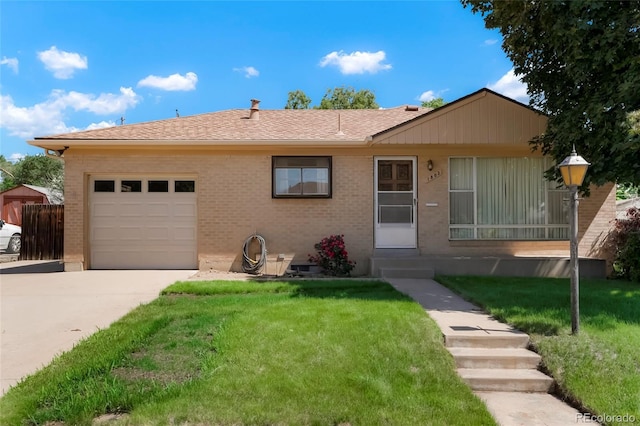 1803 Graves Ct, Northglenn, CO 80233 - view of front facade featuring a garage, driveway, brick siding, a front lawn, and roof with shingles