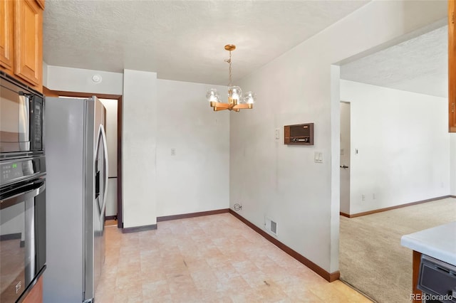 1803 Graves Ct, Northglenn, CO 80233 - kitchen with stainless steel refrigerator with ice dispenser, wall oven, a chandelier, black microwave, and hanging light fixtures