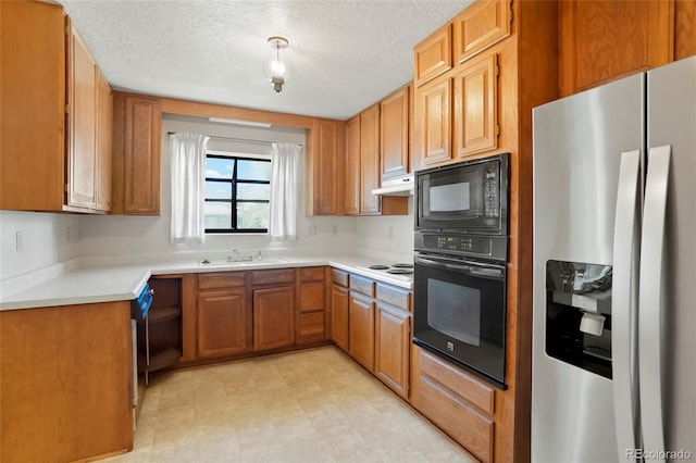 1803 Graves Ct, Northglenn, CO 80233 - kitchen featuring black appliances, light countertops, brown cabinets, a textured ceiling, and under cabinet range hood