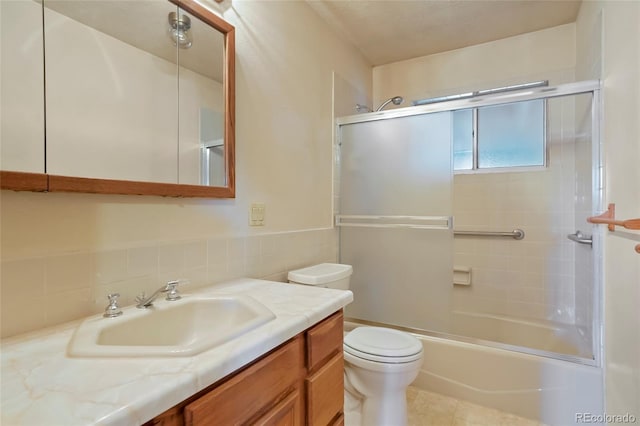 1803 Graves Ct, Northglenn, CO 80233 - full bathroom with vanity, combined bath / shower with glass door, tile patterned flooring, and tile walls