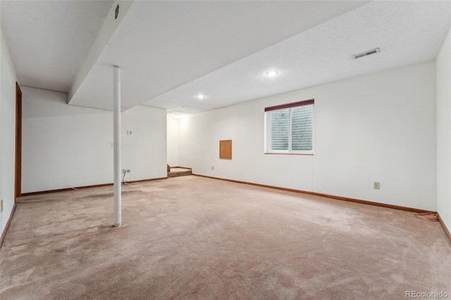 basement featuring carpet floors, recessed lighting, baseboards, and visible vents