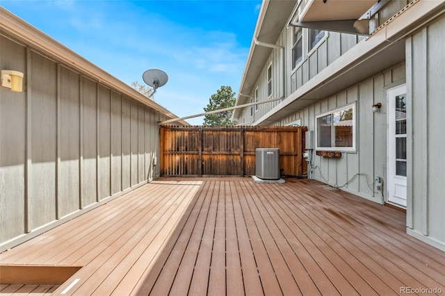 wooden deck featuring fence and cooling unit