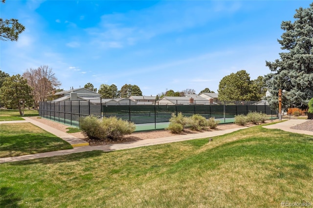view of sport court featuring a lawn and fence