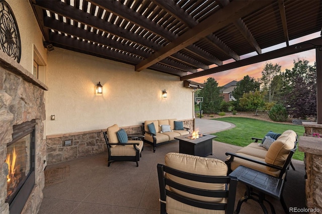 patio terrace at dusk with outdoor lounge area and a yard