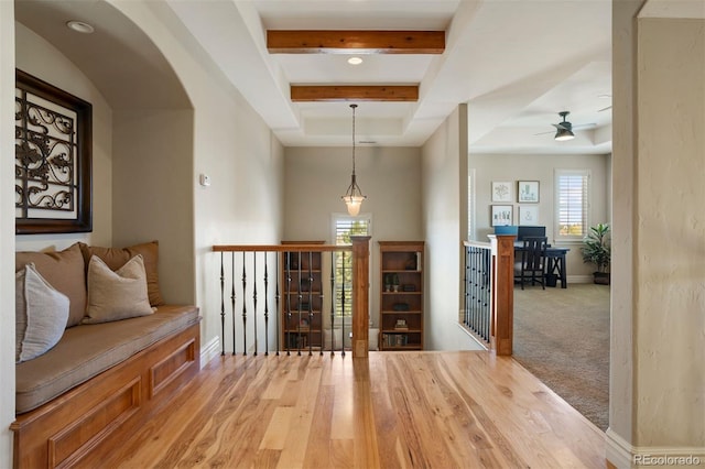 hall featuring light hardwood / wood-style flooring and beamed ceiling