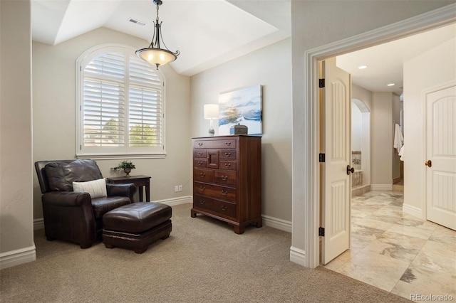 sitting room featuring light colored carpet and vaulted ceiling