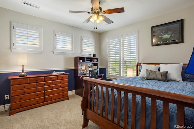 bedroom with ceiling fan and light colored carpet