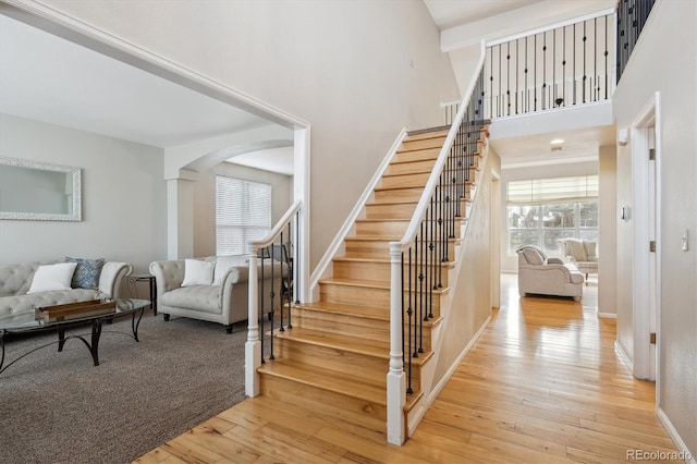 staircase with hardwood / wood-style flooring