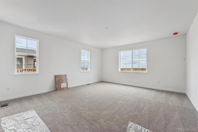 25283 E Warren Pl, Aurora, CO 80018 - spare room featuring healthy amount of natural light, carpet flooring, and baseboards
