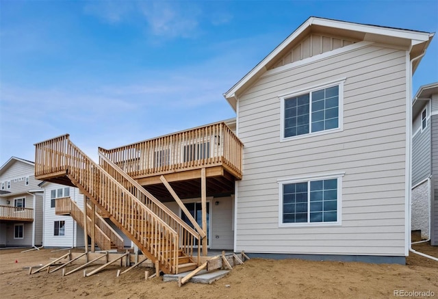 25283 E Warren Pl, Aurora, CO 80018 - rear view of house with a deck, stairs, and board and batten siding