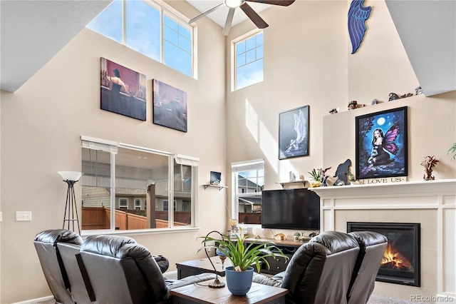 living room featuring plenty of natural light, ceiling fan, and a fireplace