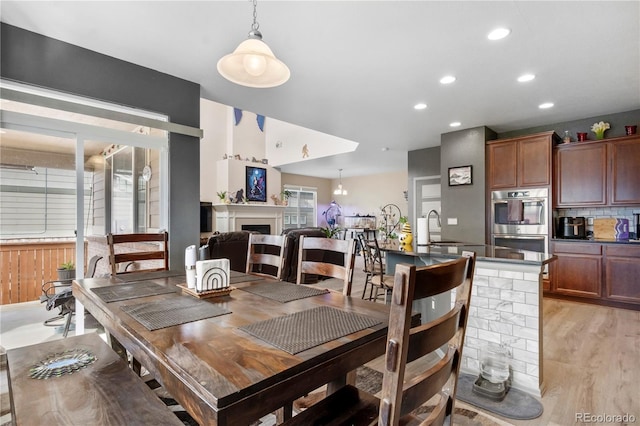 dining room with sink and light hardwood / wood-style floors