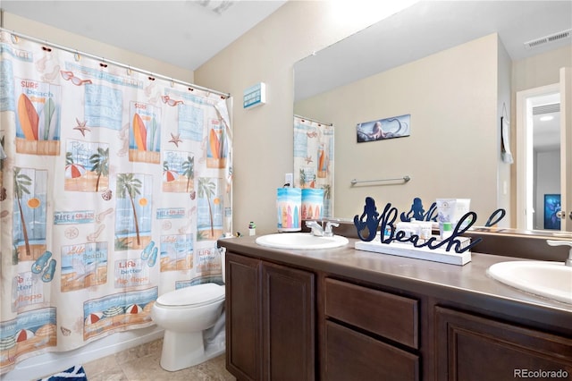 full bathroom with tile patterned floors, vanity, shower / bath combo, and toilet