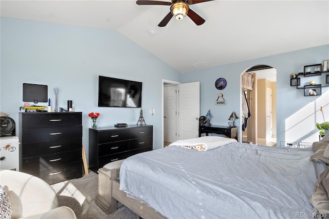 carpeted bedroom with vaulted ceiling and ceiling fan