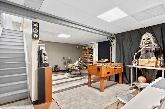 playroom featuring a paneled ceiling