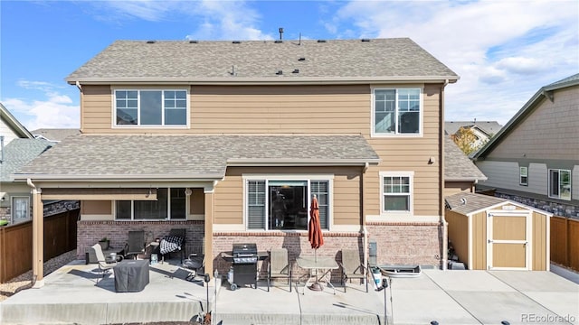 rear view of house featuring a patio and a storage unit