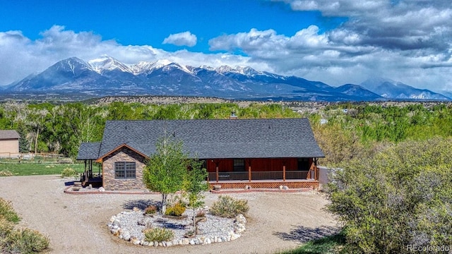 8126 Buck Run, Salida, CO 81201 - view of front facade with a mountain view, driveway, and a porch